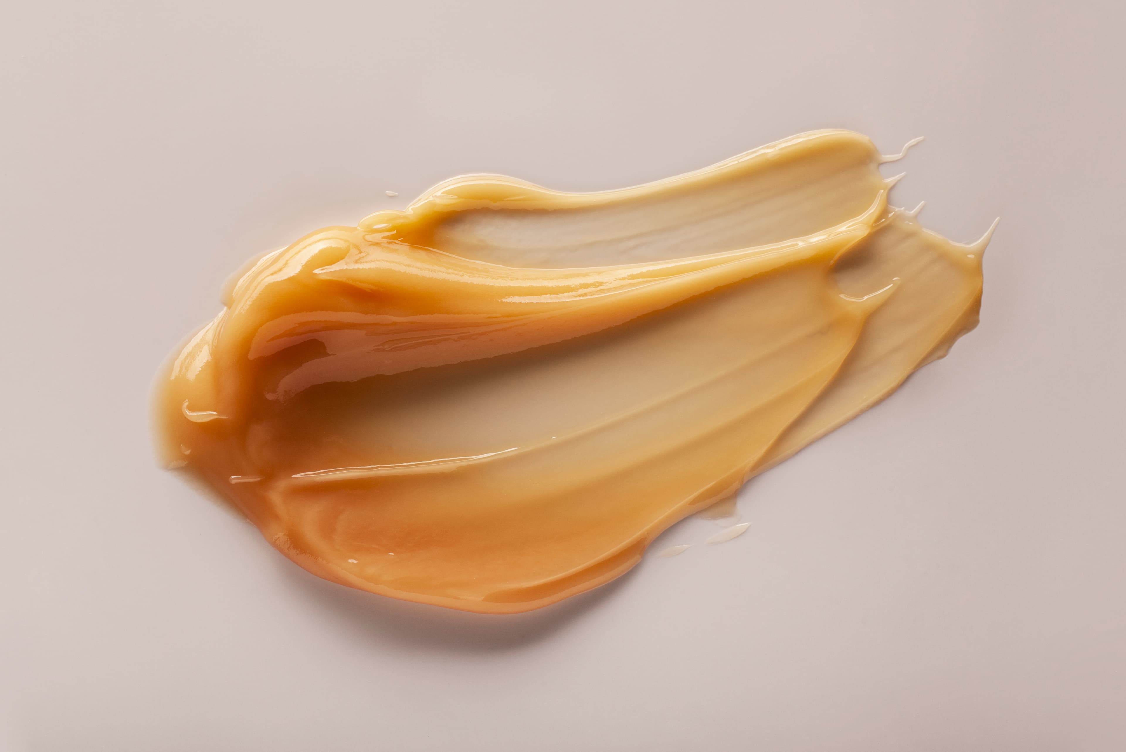 Golden balm spread on a beige background