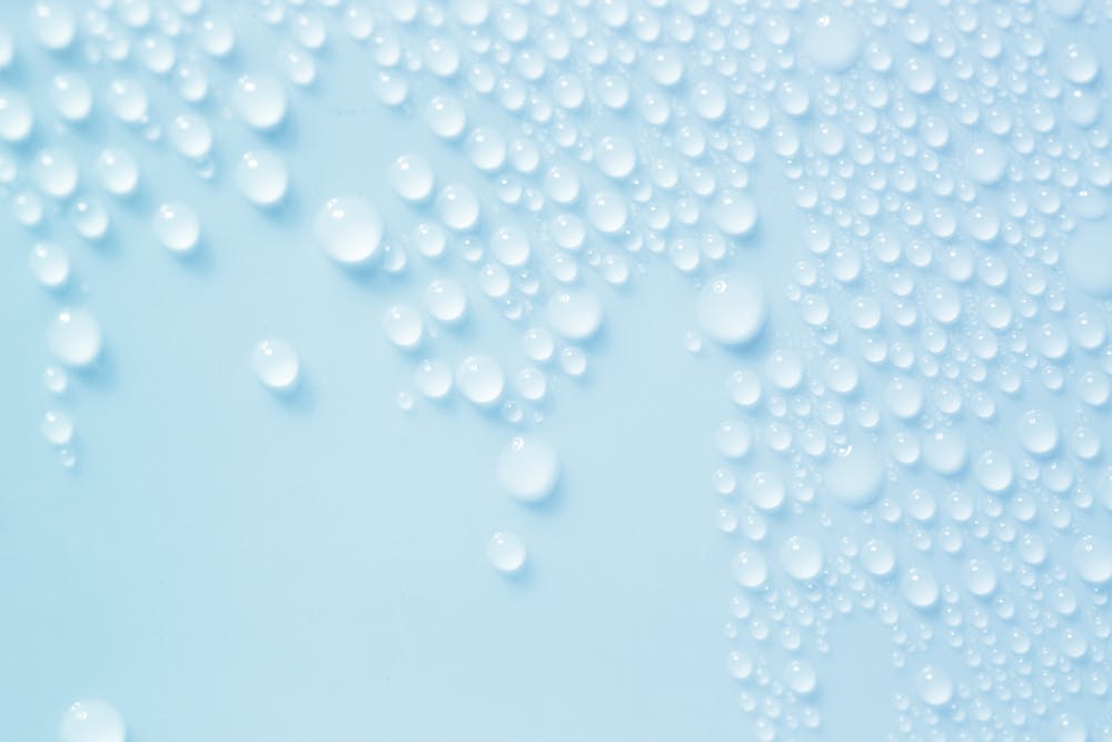 Water droplets on a pale blue background