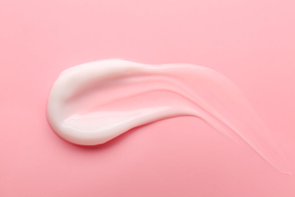 White cream on a pink background