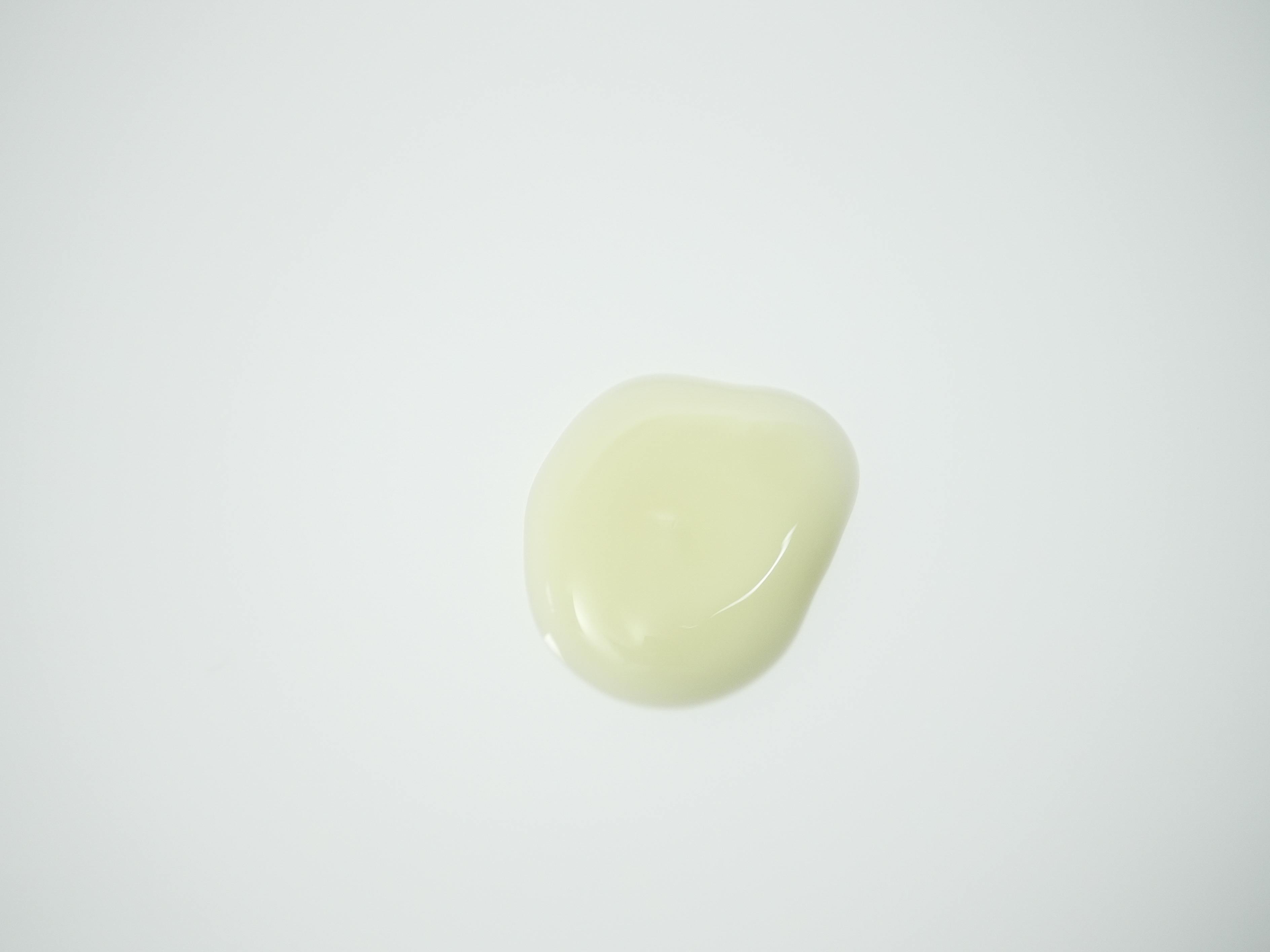 Pale yellow serum on a white background