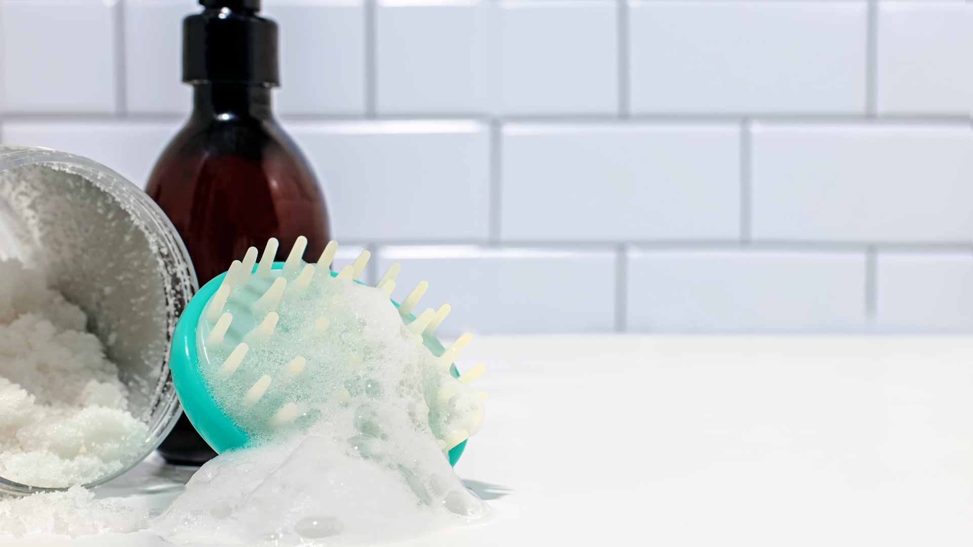 A scrubber with foam on a white tile background