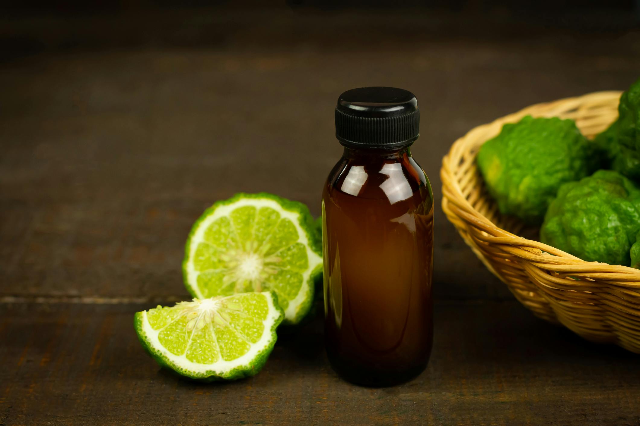 Oil bottle next to a basket of limes